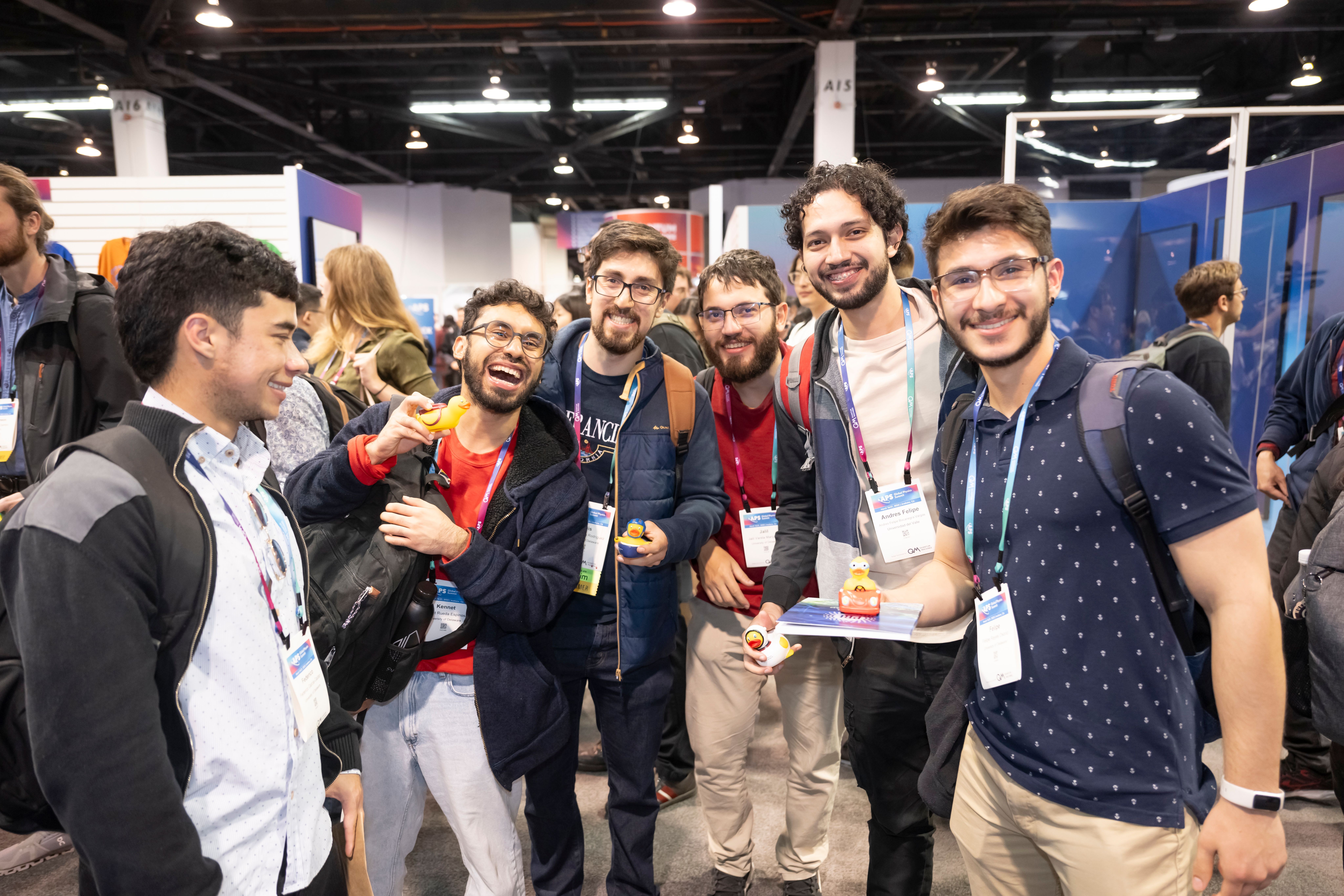 A group of conference attendees smiling for a photo.